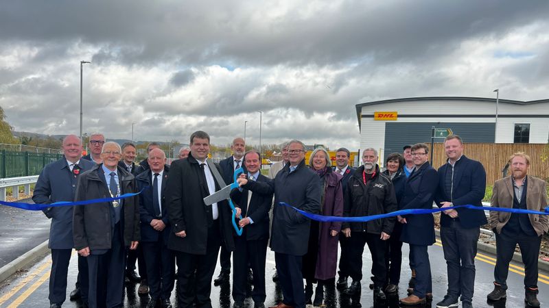 A ribbon is cut with giant scissors by developers, councillors and officers at the site of a new link road in Aylesford