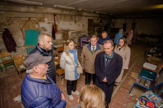 Leader of KCC Roger Gough talks to local people in the basement of a property in Chernihiv Region in Ukraine