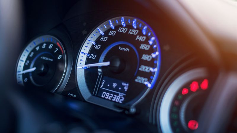 Close up of a vehicle dashboard showing the odometer