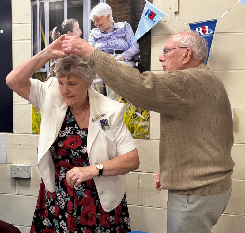 A couple dance to the sounds of the big band at a Victory in Europe 80th anniversary event