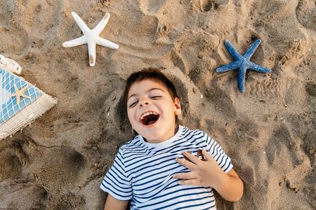 Disabled boy having fun on the beach