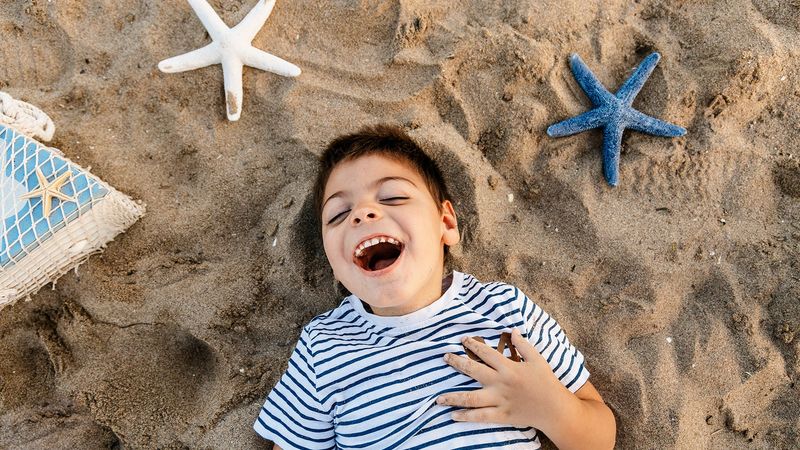Disabled boy having fun on the beach