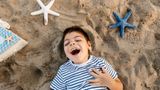 Disabled boy having fun on the beach