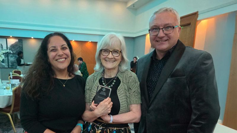 Aisha Affejee is standing next to Sue Carmichael who is holding her Libraries Connected Award. To Sue's right is James Pearson