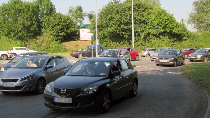 A photo of cars at a roundabout.