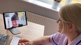 Image of a careworker talking to a female on a video tablet device (kara)
