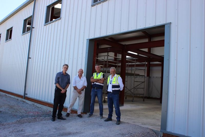 Staff standing outside the new no use empty arehouse 