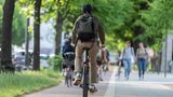 A man riding a push cycle on a cycle path