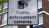 A road sign with an image of a camera and below it the sign reads: "Traffic enforcement cameras"