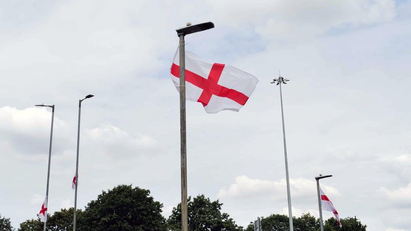 St George's flags attached to the top of lamppost and flying in the wind