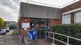 Sittingbourne Library's main entrance with brown sliding doors and a ramp up to the reception 