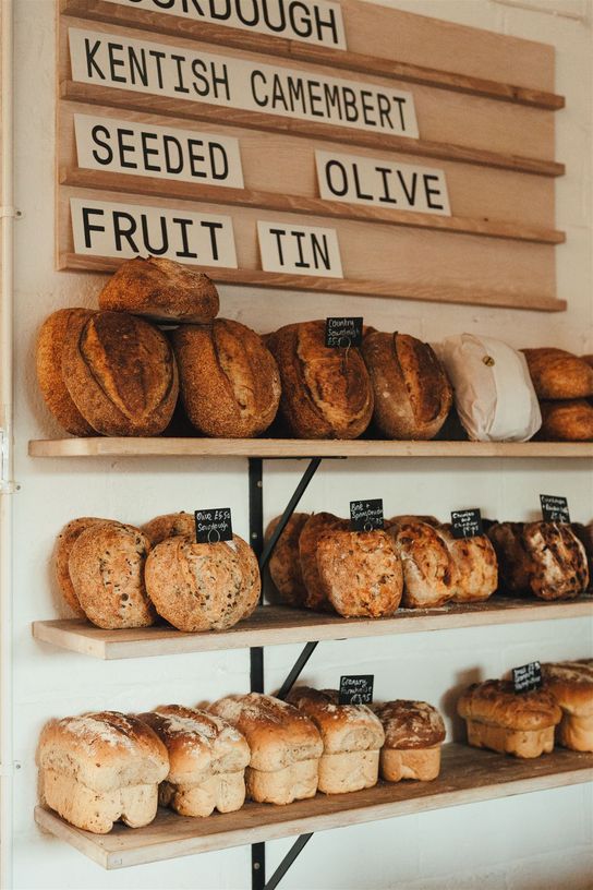 Selection of breads on display for sale at Gilda bakery in Bishopsbourne. They are stacked on wooden display racks