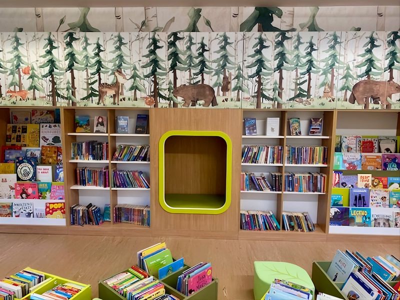 The children's section at Cranbrook Library has a woodland theme with bears, foxes, and deer features on pictures above the bookshelves