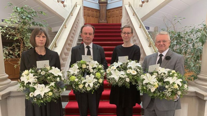 Image of four Council Members holding a wreath individually.