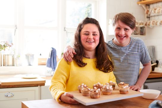 Young man and woman making cupcakes