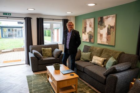 A comfysitting room with sofs and cushions