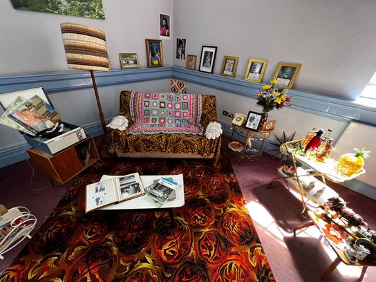 Front room display with heritage rug, sofa, ornaments and magazines 