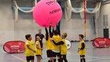 A child's sport activity with a giant inflatable ball in a sports hall