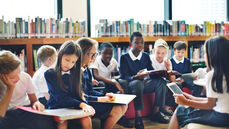 Children in a school library reading books