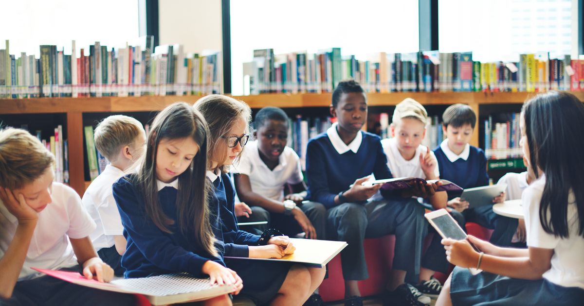 Children in a school library reading books