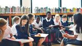 Children in a school library reading books