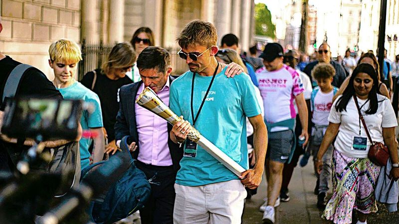 A man carrying the Baton of Hope