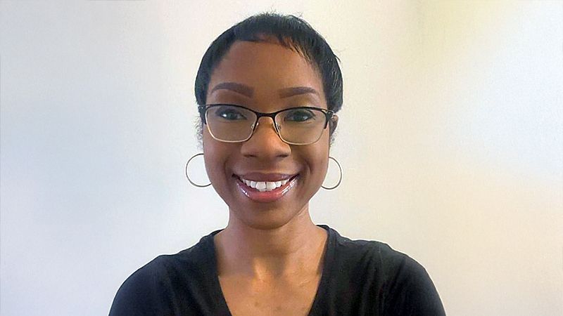 Christiana Parsons from Kent PACT wearing glasses, hoop earrings and a black top