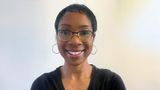 Christiana Parsons from Kent PACT wearing glasses, hoop earrings and a black top