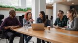 A diverse team of businesspeople having a meeting around a table