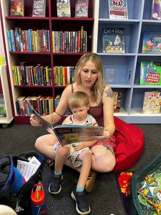 Mother reading to child at Queenborough Library