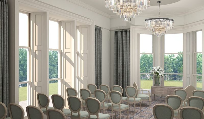 An artist impression of the Oakwood House medium ceremony room.   The room is light green interior, with a large number of green to beige chairs all facing the bay windows where the registration will take place. On the main wall is a fireplace with large mirror and above are two sparkly grand chandeliers. 