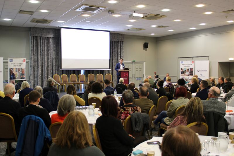 A speaker addresses the audience at the conference