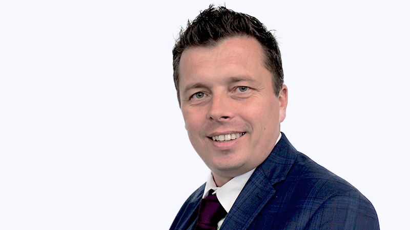 A headshot photos of Inclusion Champion Paul Owen