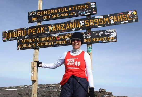Deborah Ward-Johnstone celebrating at the top of Uhuru Peak in Tanzania