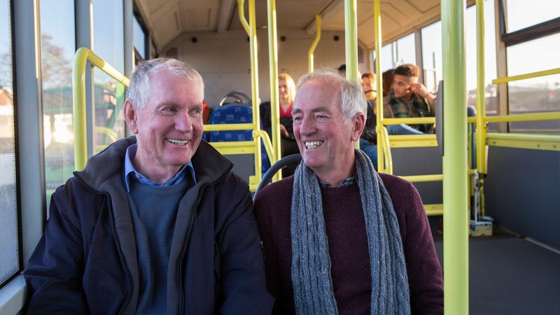 Two men sitting on a bus