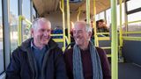 Two men sitting on a bus