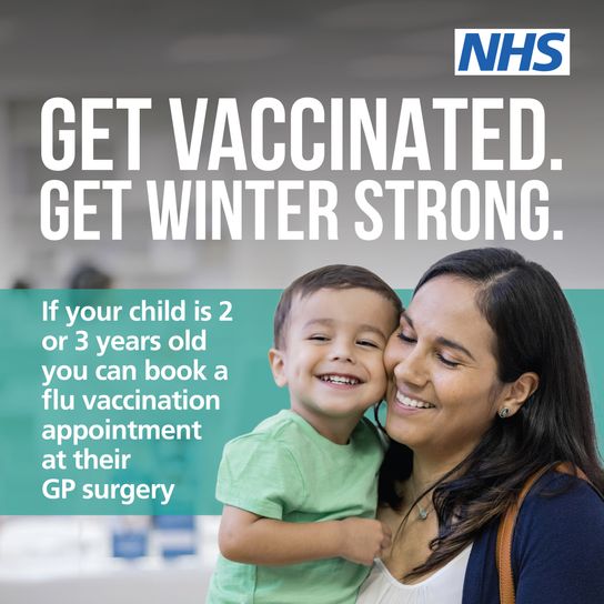 Mum and young son under 'Get vaccinated' banner 