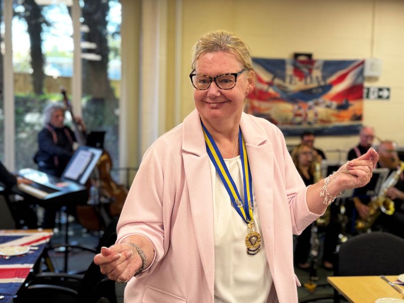 Caye Gould, Royal British Legion Kent County Chair, in peach coloured jacket dances to big band music at the Victory in Europe 80th anniversary event in Aylesford